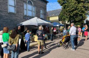 Photo of people gathering outside the hall for a Preservation Burlington event in 2022.